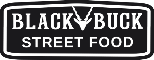 Logo featuring bold, uppercase letters on a black background within an oval border that points up , with a stylised image of a deer's head and antlers centred above the text, which reads 'STREET FOOD'.