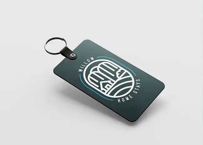 Keycard mockup featuring a dark green card with the Willow Home Stays logo, displaying a stylised house and willow tree design, accompanied by the brand name in white, set against a clean, light background.