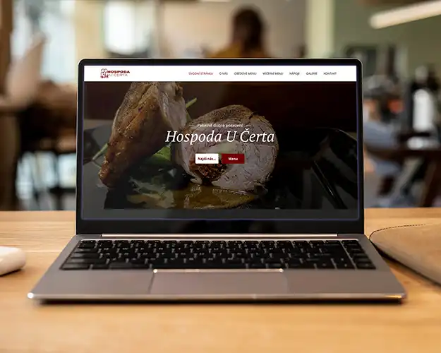 Laptop setup displaying a restaurant's website on a computer, showcasing a mouth-watering dish on the homepage, with a clean and professional design layout that includes easy-to-navigate menu options.