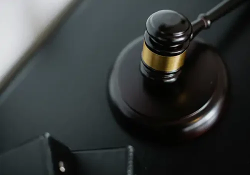 Close-up of a judge's gavel resting on a sound block, symbolising law, justice, or a legal decision.