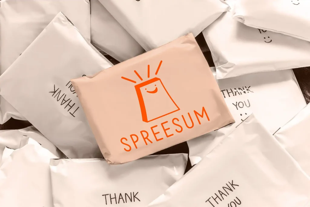 Stack of packages with a central parcel featuring the mystery shopping store logo, surrounded by other parcels labelled 'Thank You,' creating a branded and customer-focused packaging design.
