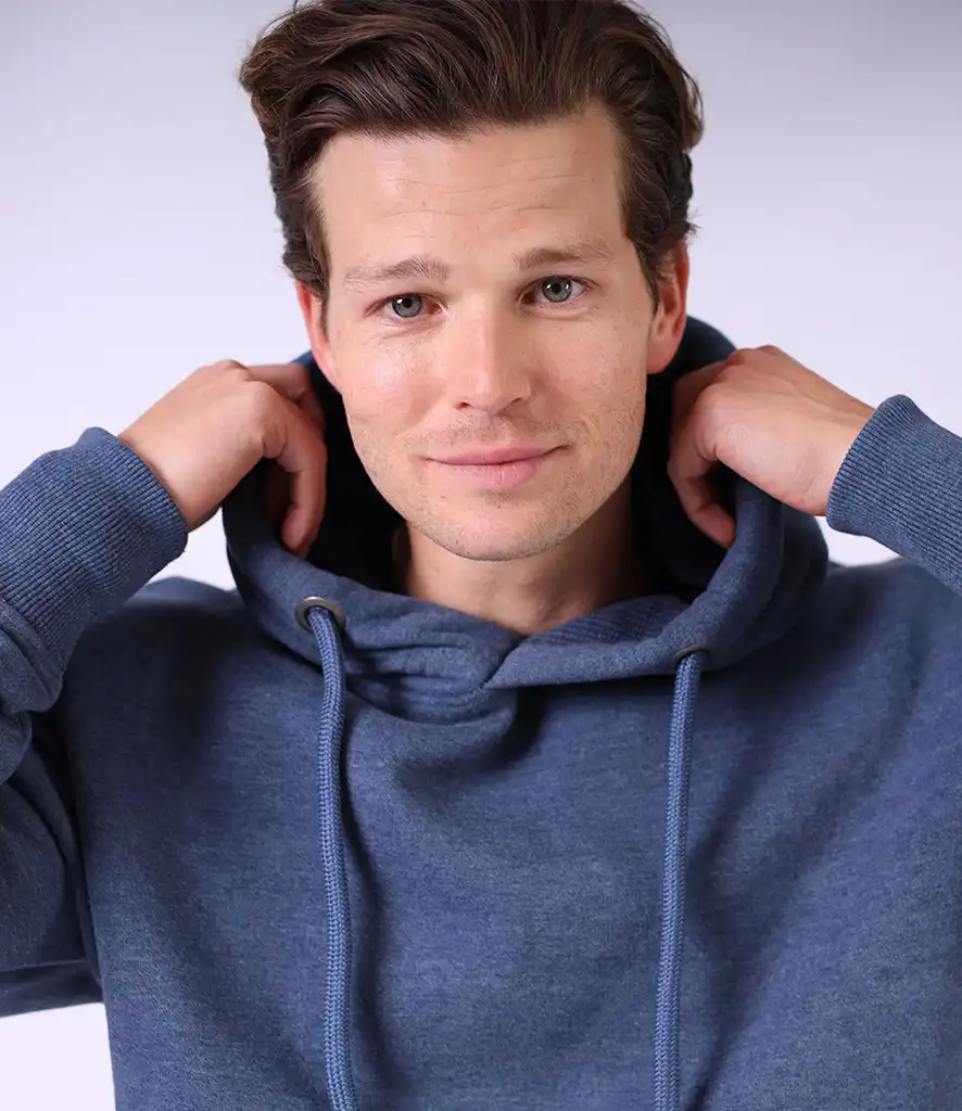 Man wearing a plain blue hoodie, ideal for custom printing or embroidery—popular for branded teamwear, events, and merchandise.