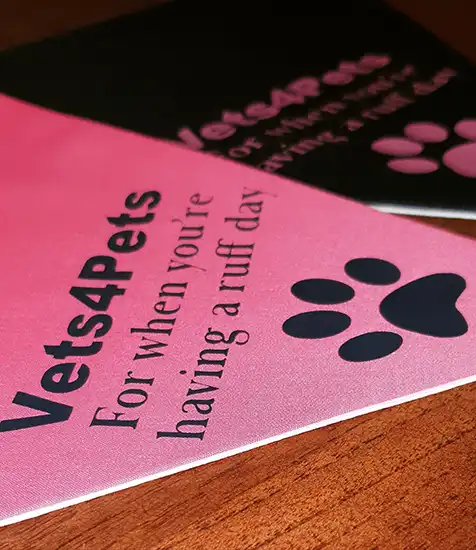 Custom printed Vets4Pets bandanas with paw print and “For when you're having a ruff day” slogan on pink and black fabric.
