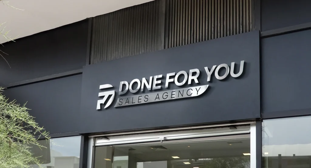Exterior signage for Done For You Sales Agency on a modern dark building frontage.